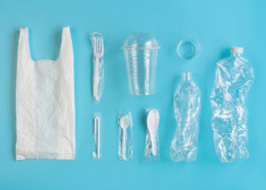 plastic grocery bag and plastic wrapped disposable cutlery. Clear plastic cup with lid, plastic water bottles.