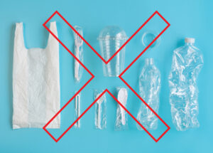 plastic grocery bag and plastic wrapped disposable cutlery. Clear plastic cup with lid, plastic water bottles - A red X covers the materials.
