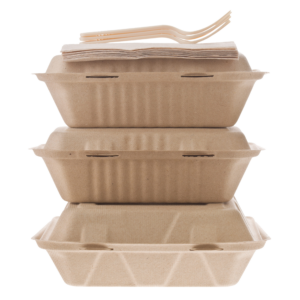 Closeup shot of three beige takeout containers with napkins and forks on top