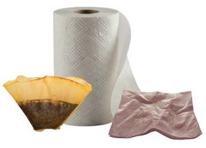 Paper towel, coffee filter full of grounds, and used napkin