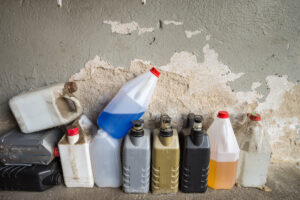 Various unlabeled bottles of household hazardous waste
