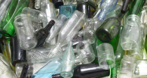 Assorted Glass Containers - clear, brown, and green.