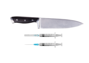 Kitchen knife and two medical syringes