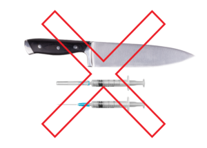 Kitchen knife and two medical syringes