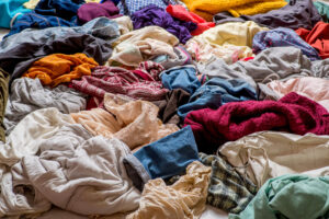 Pile of used clothing in various colors